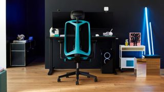 Herman Miller Vantum marketing image showing the Blue variant standing out from a dark gaming setup
