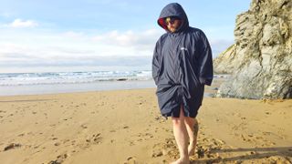 Finisterre Tego robe being worn on a beach