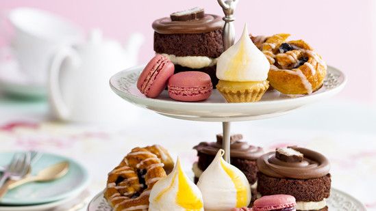 pastries with pastry serving stand and dishes