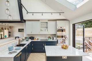 Designed by Lucy, an interior designer, the kitchen features in-frame cabinetry from 1909 Kitchens, with contemporary handles from Buster + Punch.