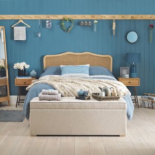 Blue bedroom with wooden bed