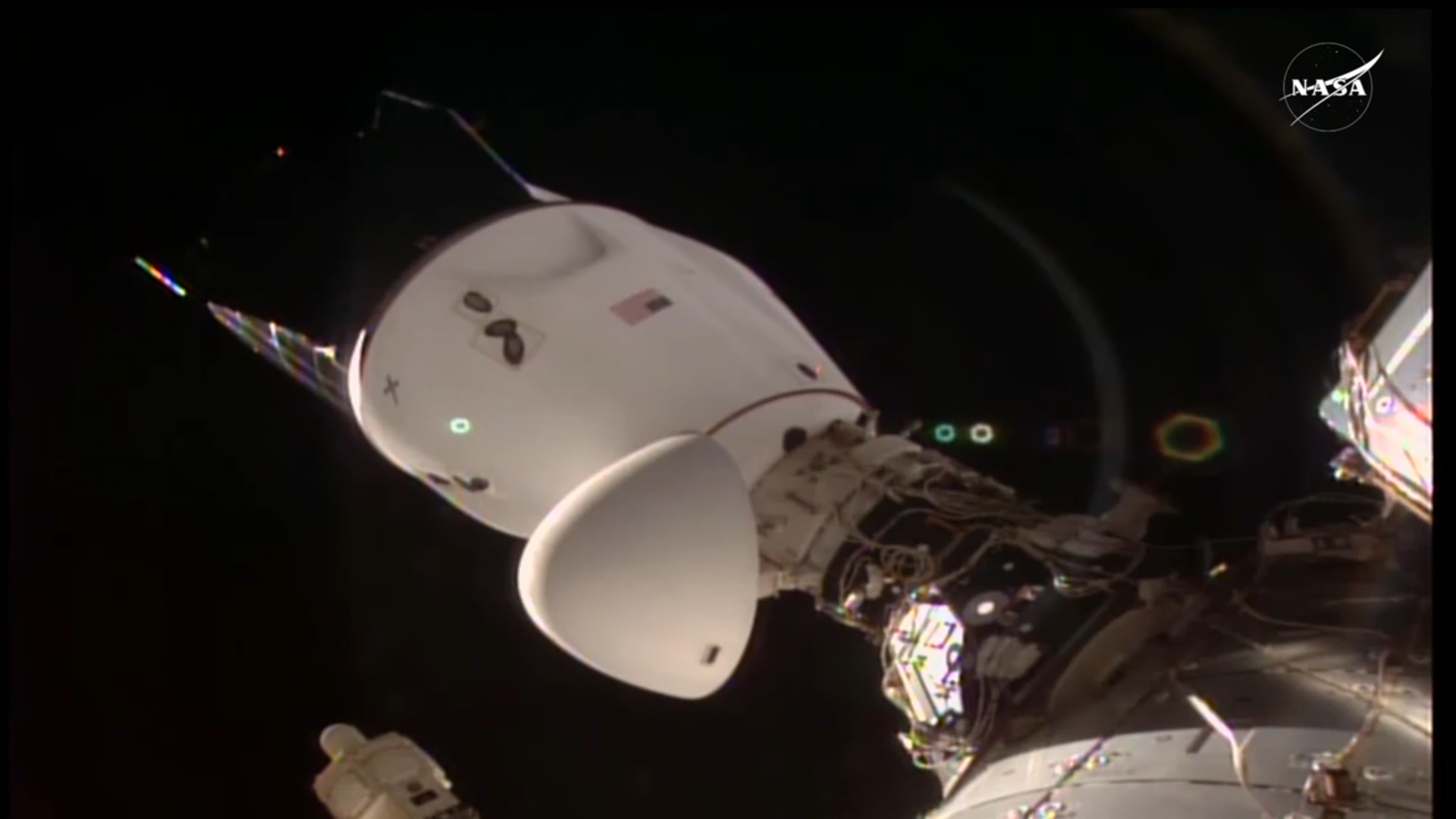 A SpaceX Dragon space capsule docked at the International Space Station with nosecone open