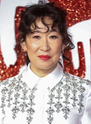 Sandra Oh pictured with red lipstick and black eyeliner