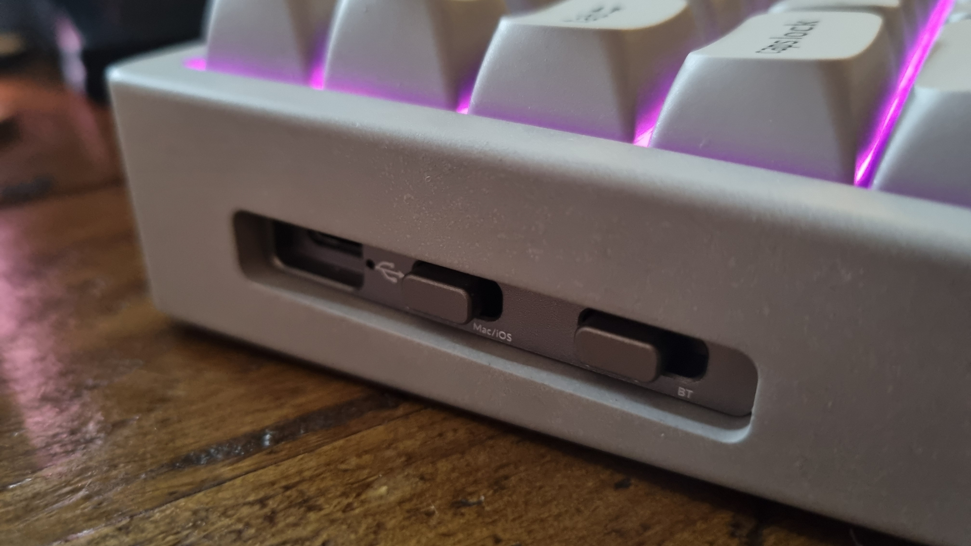 Various angles of a Keychron K2 HE Concrete Edition keyboard lit up in RGB lighting