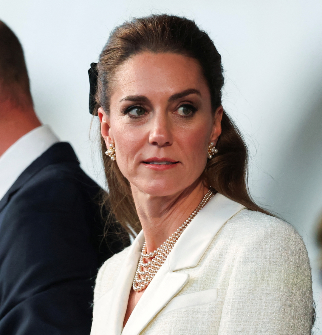 Kate Middleton wearing a white tweed blazer dress and pearl necklace at a VE Day anniversary concert