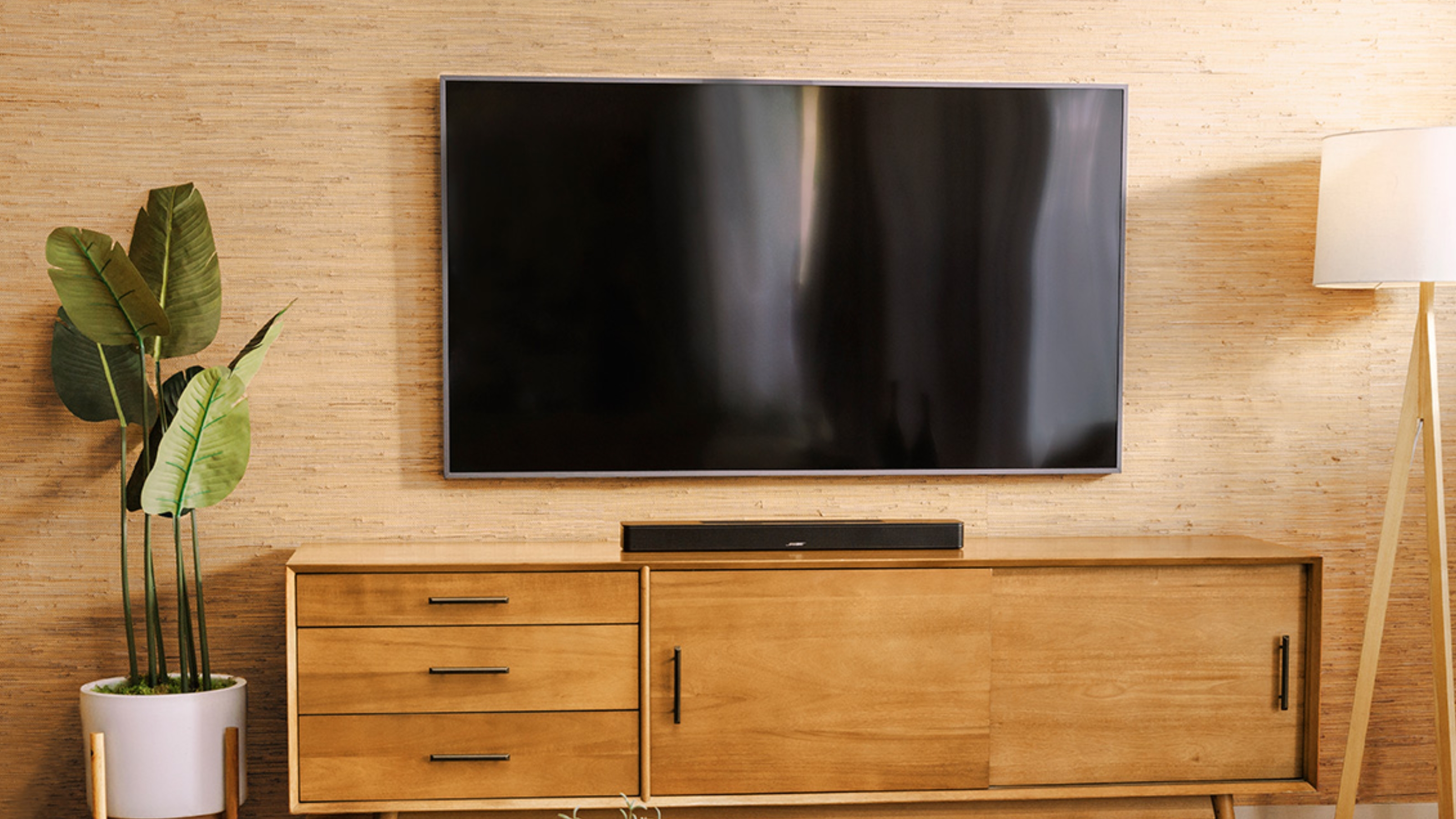 a tv in a modern living room with a soundbar underneath