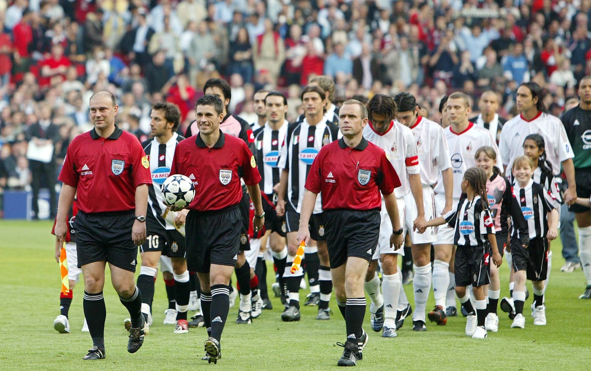 Juventus and AC Milan players head out onto the pitch ahead of the 2003 Champions League final at Old Trafford.