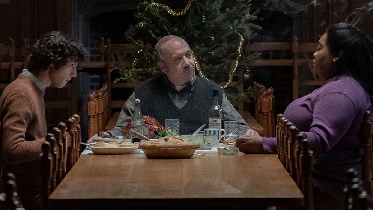 Dominic Sessa, Paul Giamatti and Da&#039;Vine Joy Randolp sitting around the dinner table at Christmas in The Holdovers