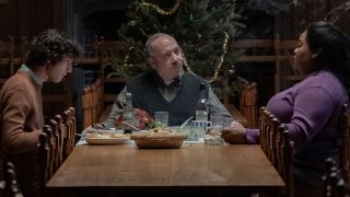 Dominic Sessa, Paul Giamatti and Da'Vine Joy Randolp sitting around the dinner table at Christmas in The Holdovers