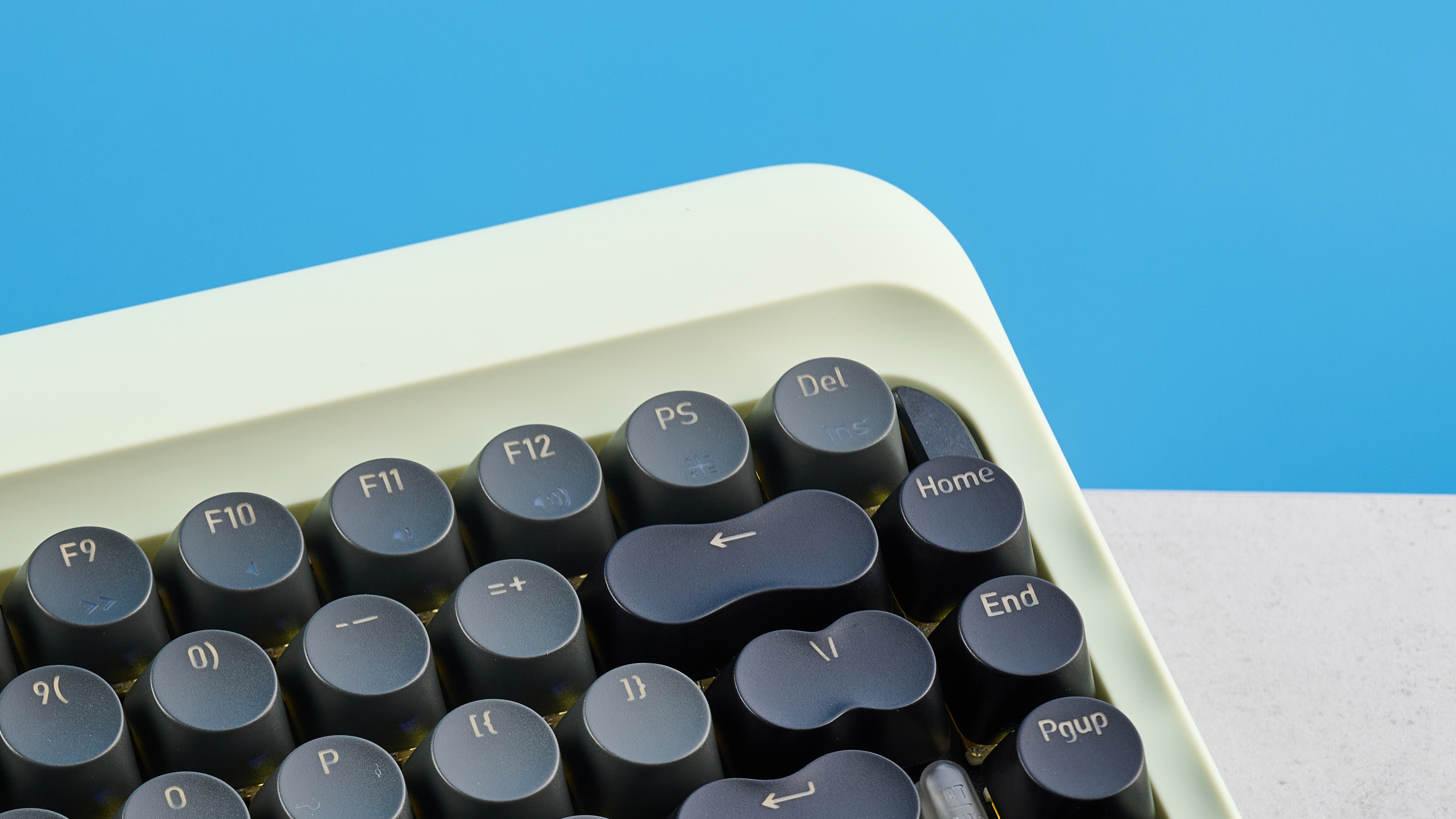 The Lofree DOT on a stone surface with its upper right keys showing