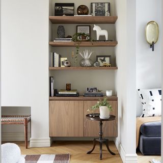 Beige living room with oak built-in shelves.