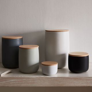 Coffee canisters from West Elm in different sizes and colors on the countertop