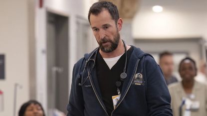 Dr. Robby looks forlorn while walking through the hospital hallway