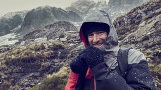 waterproof versus water-resistant: hiker in waterproof jacket
