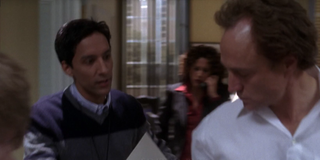 The West Wing Danny Pudi Santos Aide hands paper to Josh Lyman