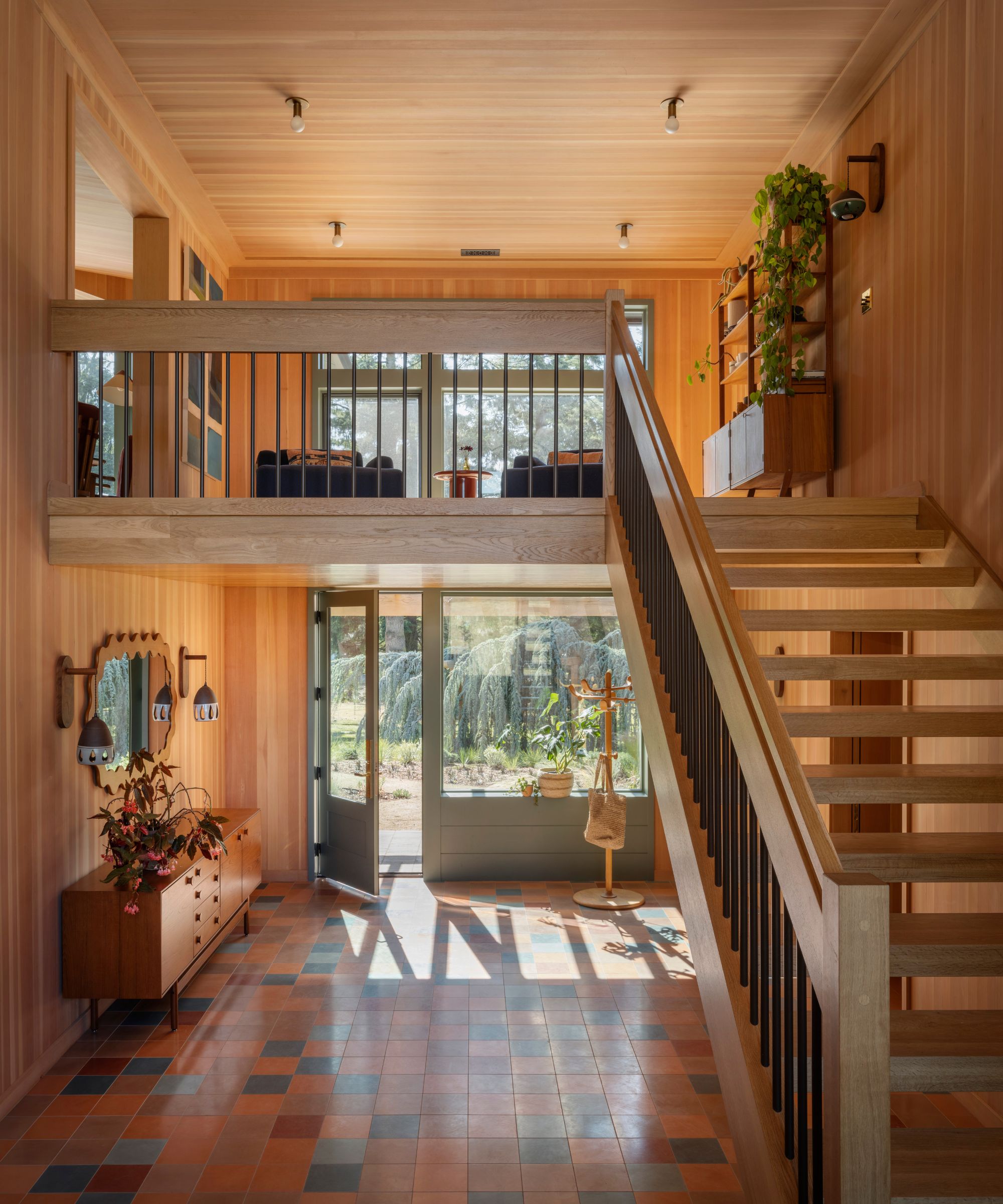 light bright entryway of a 1970s river house with wood panelling all over