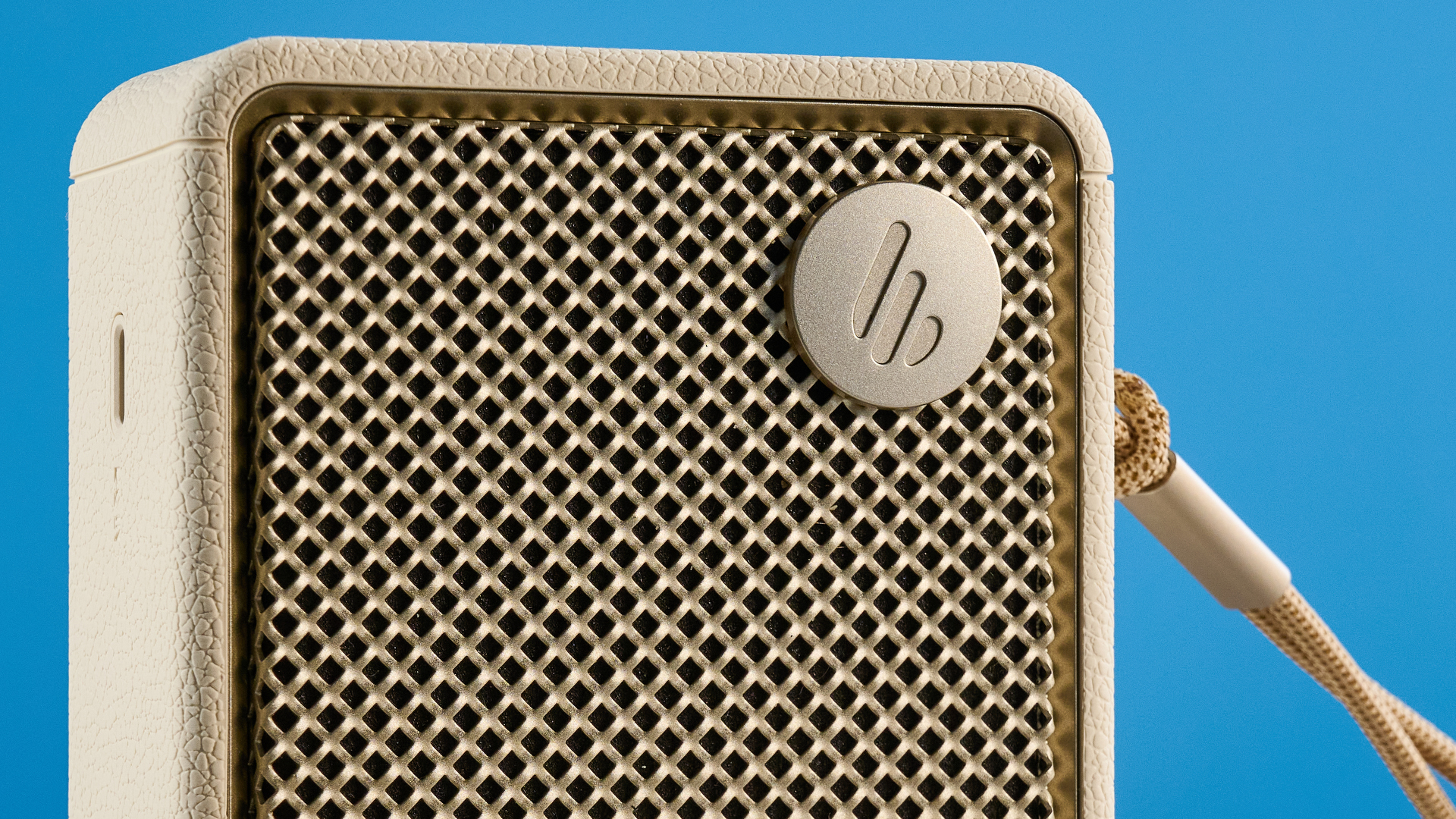 Edifier ES20 Bluetooth speaker in ivory colorway photographed on a blue background