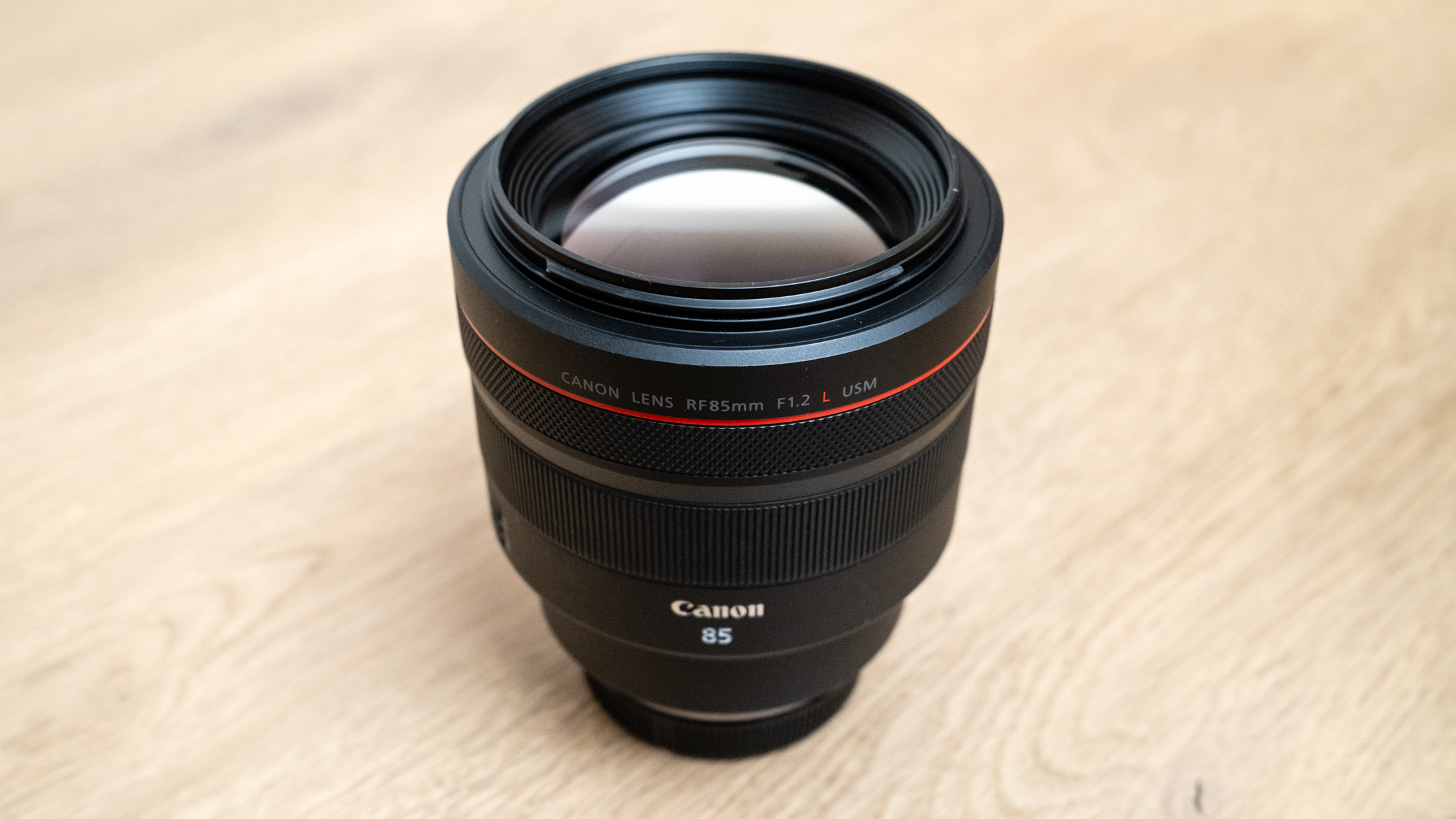 Canon RF 85mm f/1.2L USM on a wood floor