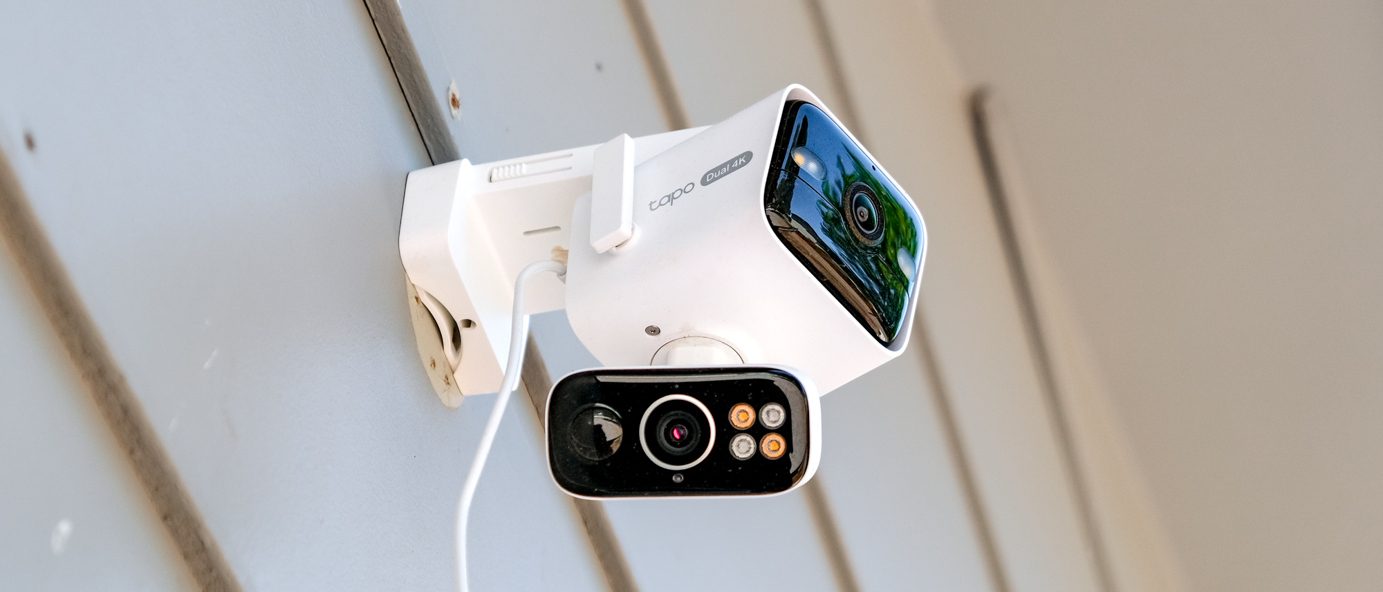 TP-Link Tapo C675D security camera mounted to the side of a house
