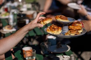 A cyclist reaches for a sticky fruit bun