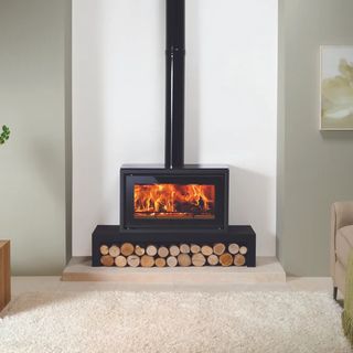 black stove bench on cream hearth with black stove on top and logs below