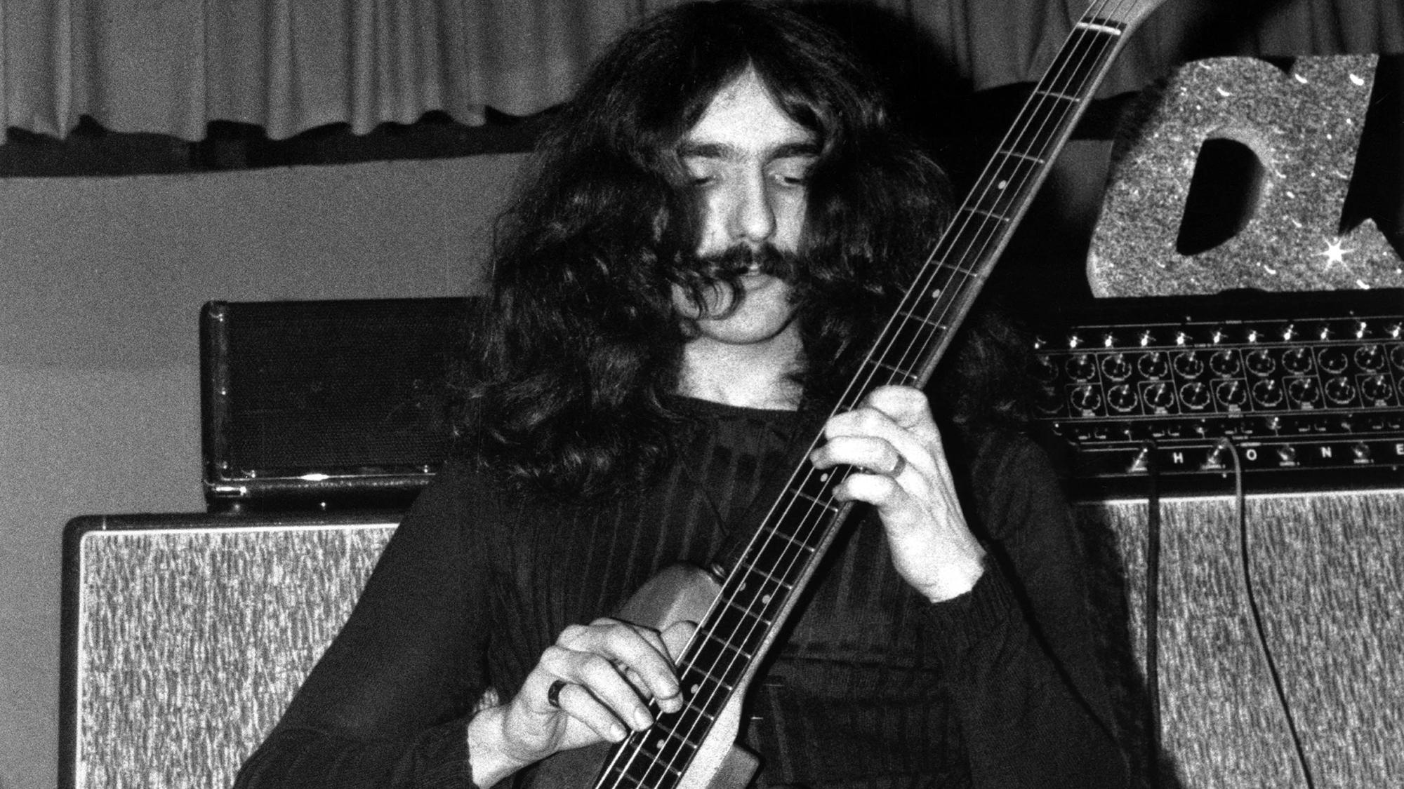 Geezer Butler performing on stage in Earth, the predecessor to Black Sabbath