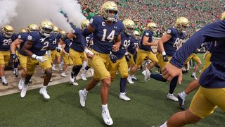 Notre Dame college football teams running out onto the field at the start of a game in &#039;Here Come the Irish&#039;