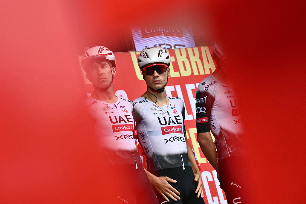 Team UAE&#039;s Spanish rider Juan Ayuso is presented on stage before the start of the second stage of the Vuelta a Espana, a 159,6 km race between Alba and Limone Piemonte, in Italy&#039;s Piemonte region, on August 24, 2025. (Photo by Marco BERTORELLO / AFP)
