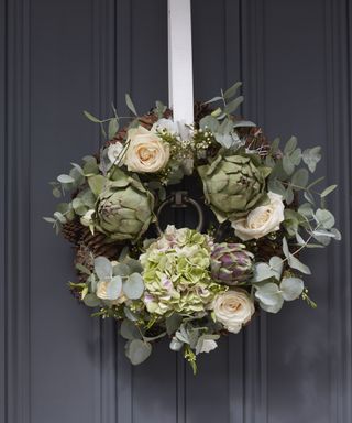 Thanksgiving wreath ideas with a wreath made from eucalyptus, artichokes and winter roses