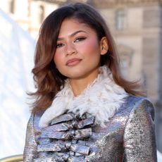 Zendaya posed with fans in Paris wearing a white tank top and sparkly micro-mini shorts