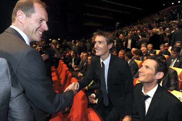 Christian Prudhomme, the Tour de France director, greets the Schleck brothers.