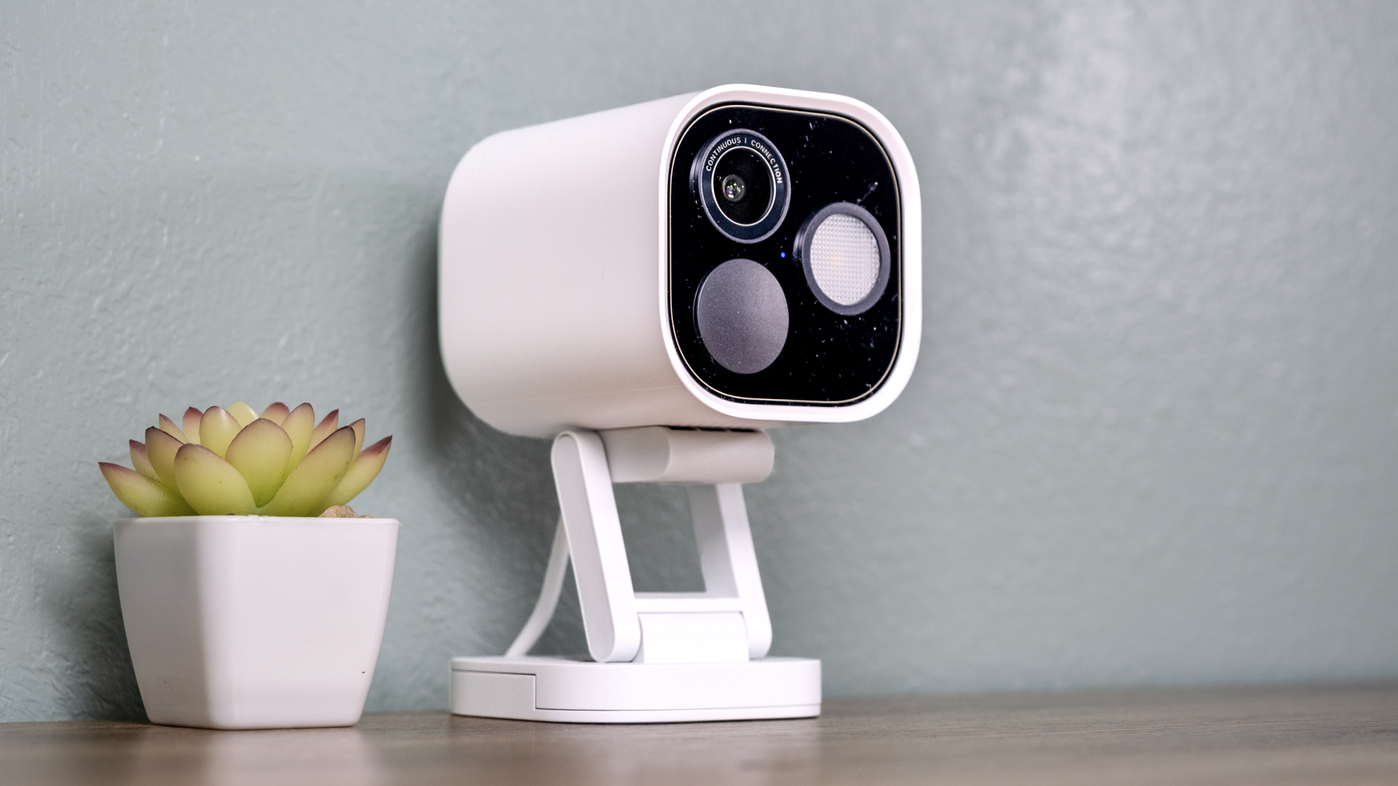 Aqara Camera Hub G5 Pro on a shelf with a small cactus.