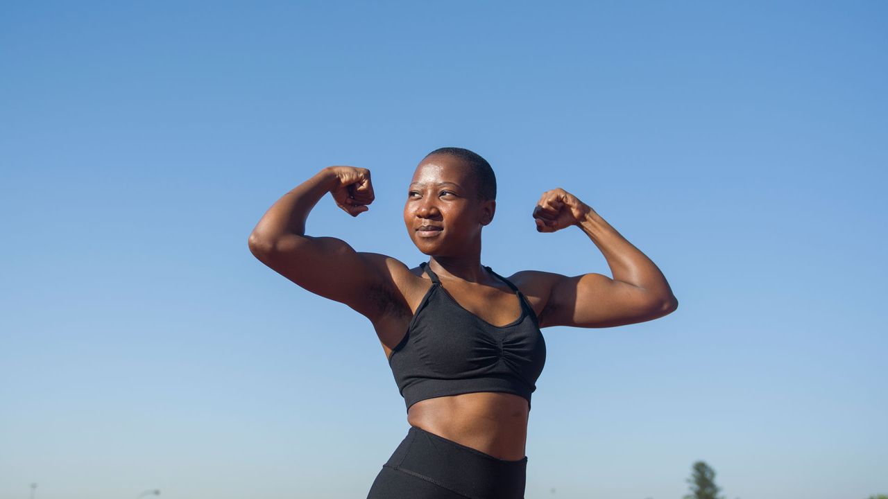 Woman flexing bicep muscles