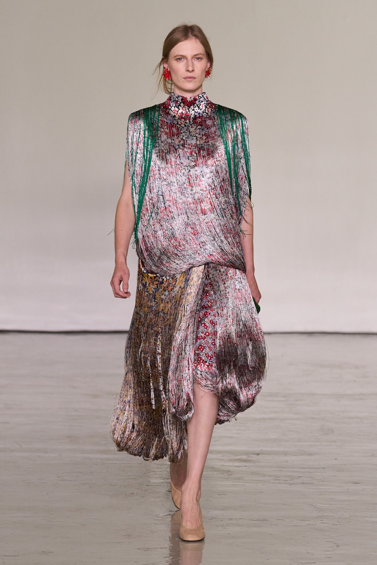 A model walking in the spring/summer 2027 Bottega Veneta show during Milan Fashion Week wearing a fringe dress.