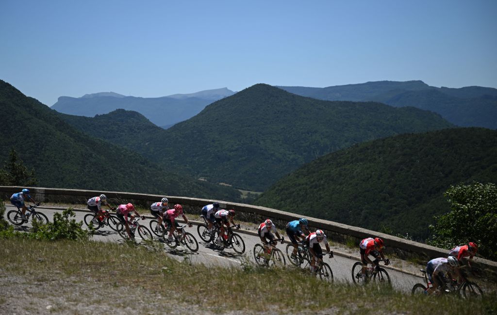 The pack of riders cycles during the sixth stage of the 74th edition of the Criterium du Dauphine cycling race 1965 km between Rives and Gap central eastern France on June 10 2022 Photo by Marco BERTORELLO AFP Photo by MARCO BERTORELLOAFP via Getty Images