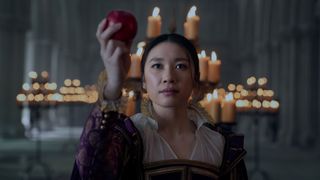 Jin Cheng holds up an apple in a fantasy VR setting in Netflix's 3 Body Problem TV show