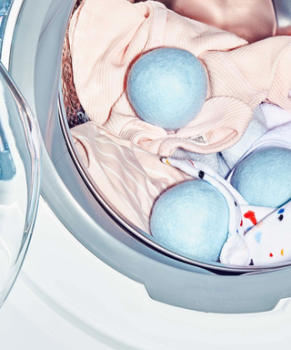 A trio of light blue pastel dryer balls in a machine with towels