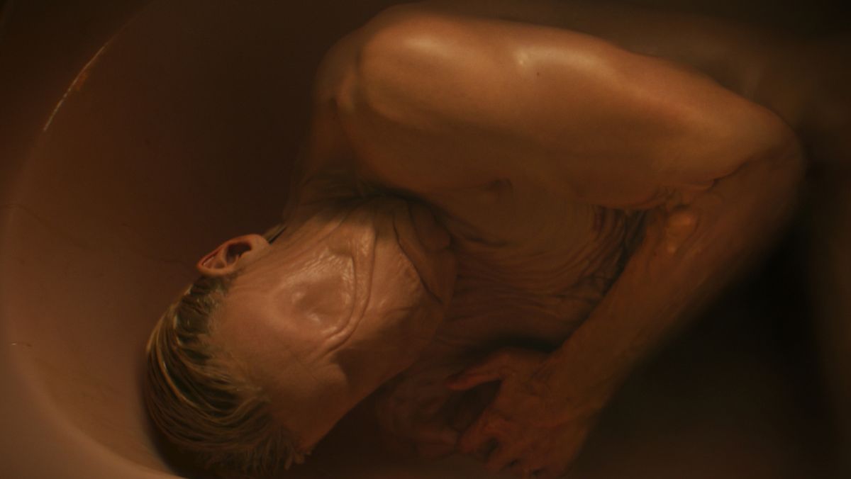 Matt Hagen lying in a bathtub with his shape-shifting abilities on show in Clayface