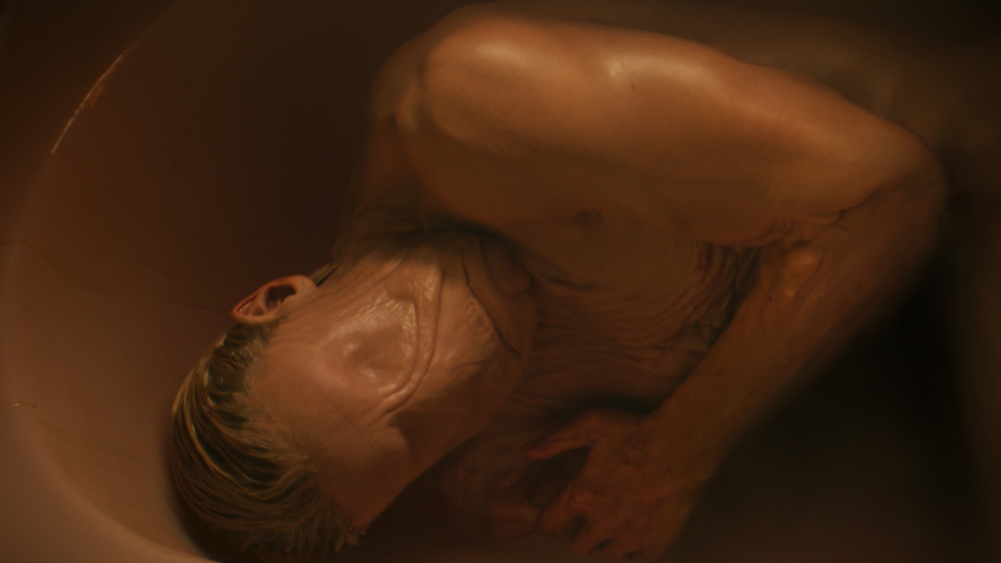 Matt Hagen lying in a bathtub with his shape-shifting abilities on show in Clayface
