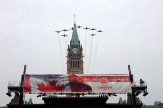 The Snowbirds Demonstration Team (431 Squadron) flies above Ottawa's Parliament Hill as part of Canada Day festivities.