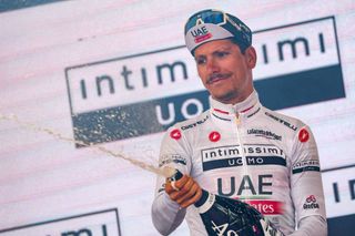 UAE Team Emiratess Portuguese rider Joao Almeida sprays sparkling wine as he celebrates his best young riders white jersey on the podium after the twelfth stage of the Giro dItalia 2023 cycling race 179 km between Bra and Rivoli on May 18 2023 Photo by Luca Bettini AFP Photo by LUCA BETTINIAFP via Getty Images