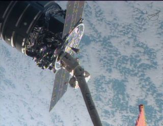 This close-up shows the first Cygnus commercial cargo spacecraft built by Orbital Sciences Corp. attached to the end of the robotic arm on the International Space Station after the two spacecraft met at 7 a.m. ET on Sept. 29, 2013.