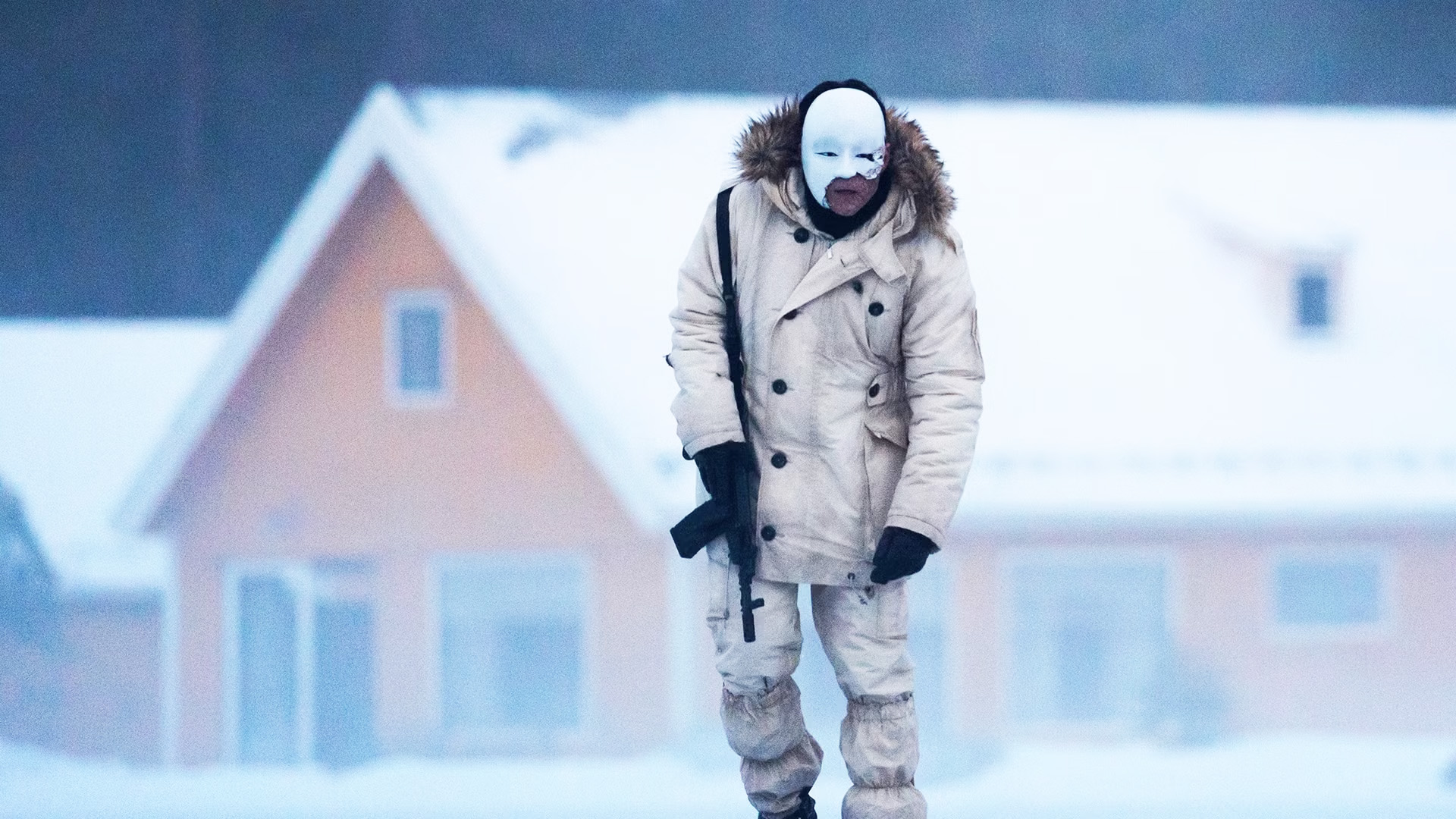 No Time to Die still – Rami Malek as Lyutsifer Safin in snowy scene wearing mask and holding gun