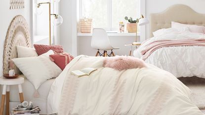 Two white beds with pink pillows