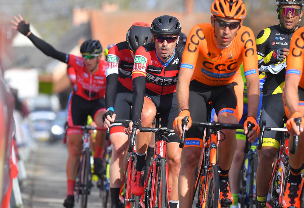A rider raises his arm for service at Nokere Koerse