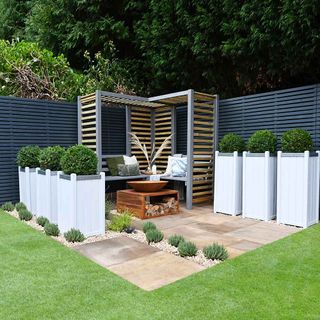 clack timber fence around a courtyard garden seating area