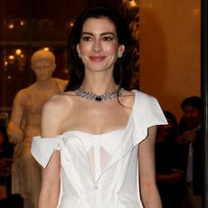 Anne Hathaway wears a Gap deconstructed shirt dress while attending a Bulgari fashion show