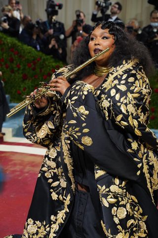 Lizzo plays the flute at the 2022 Costume Institute Benefit celebrating In America: An Anthology of Fashion at Metropolitan Museum of Art on May 02, 2022 in New York City.