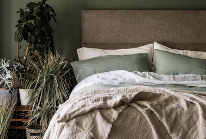 green bed linen on a comfortable bed