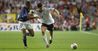 Michael Ballack of Germany takes the ball past Tony Sanneh of the USA during the FIFA World Cup Finals 2002 Quarter Finals match played at the Ulsan-Munsu World Cup Stadium, in Ulsan, South Korea on June 21, 2002. Germany won the match 1-0.
